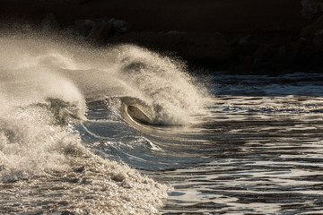 Powerful waves and revolts in agitated sea completely in troubled waters