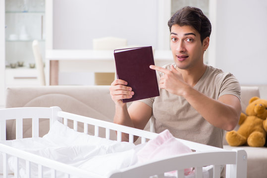 Young dad student preparing for exams and looking after baby
