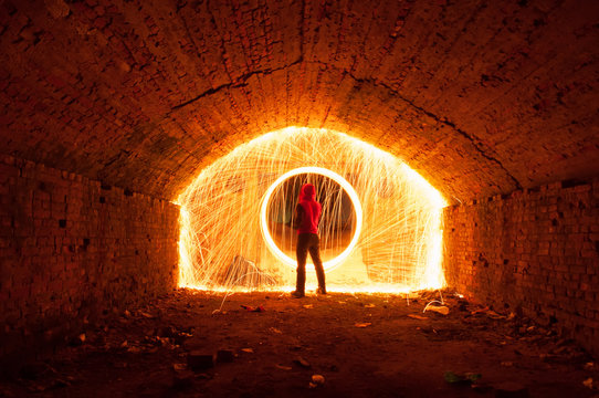 2883255 A man in a red hood opened a portal, a circle of sparks,