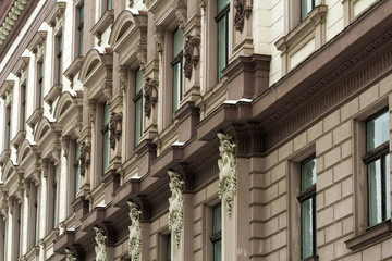 Detail image of facade of an old building. Windows and decoration of walls made in old style. Unique architecture