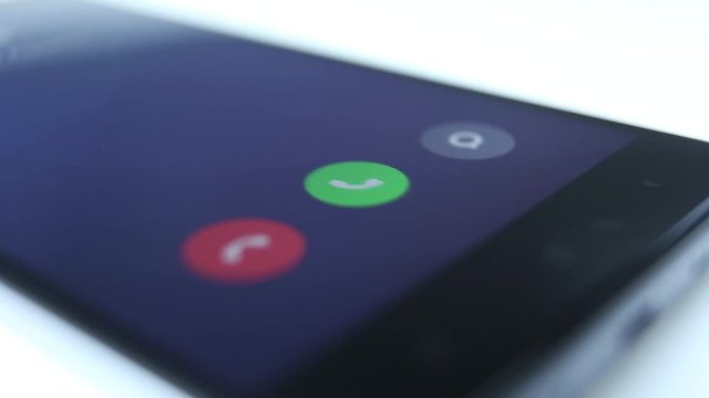 Incoming phone call indication on smartphone display close-up, Answering an incoming call