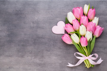 Mother's Day, woman's day, easter, pink tulips, presents on gray  background.