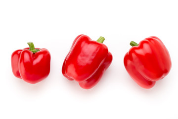 Red bell pepper with half and leaves isolated on white.