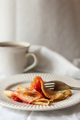 Pancakes (crepes) with berries and sweet jam