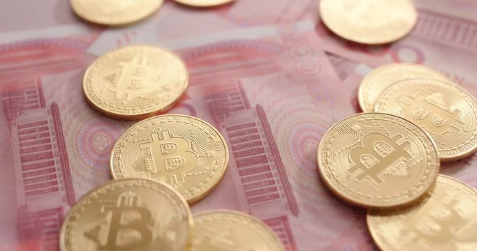 Chinese banknote and bitcoin in spinning