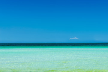 Turquoise sea water and blue sky background.