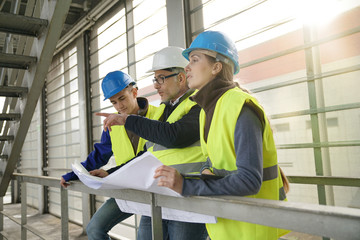 Construction site manager with young people in training period