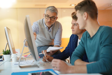 Teacher with students in computing class