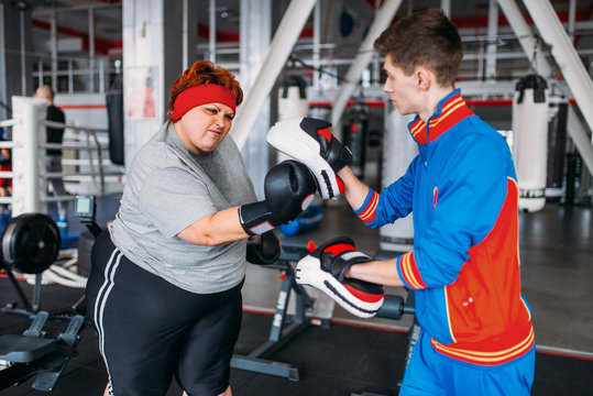 Fat woman makes selfie with instructor in gym