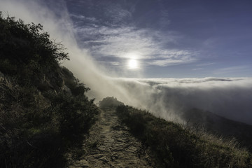 Morning coastal fog engulfing Rocky Peak Park hiking trail above the San Fernando Valley in Los Angeles California.  