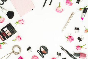 Workspace with cosmetics, accessories and pink roses on white background. Top view. Flat lay