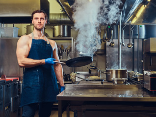The chef holds dry pan.