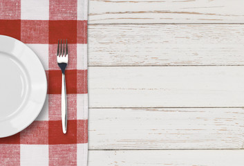 Fototapeta na wymiar dinner plate, knife and fork setting on white table top view