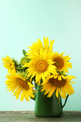 Bouquet of sunflowers on mint background