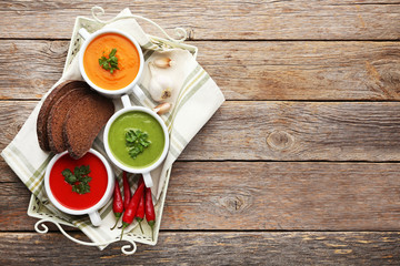 Vegetable cream soup with parsley on grey wooden table