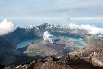 Rinjani crater lake from the above with levitating cloud and mountain around, Lombok, Indonesia
