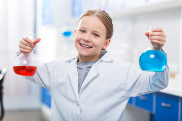 Joyful gay girl experimenting with liquids