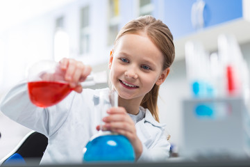 Curious little girl combining liquids