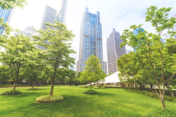 Modern architecture of Shanghai, China. Lujiazui Central Greenland with green trees and lawns. Travel background.