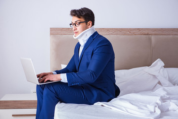 Businessman with neck injury working from home