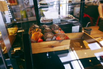 Fresh muffins in shop window in coffee house