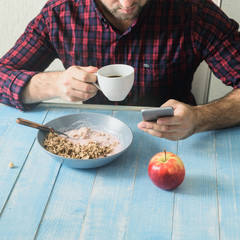 Healthy breakfast concept. Man eats porridge with yogurt