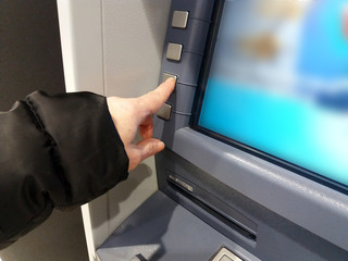 finance, money, bank and people concept - close up of hands choosing option on atm machine