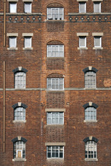 Brick wall and windows pattern on a disused industrial building in Tewkesbury, Gloucestershire, UK