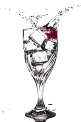 Strawberry splashing into glass of water