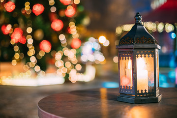 Christmas Lantern With Burning Candle On Bright Blurred Christmas