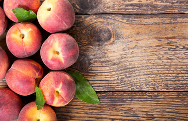 fresh peaches on a wooden table, top view