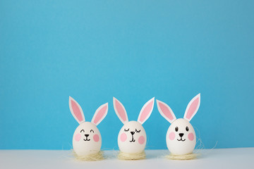 Happy Easter. Eggs with ears of rabbits, in an image of rabbits