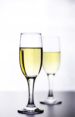glass of white wine on a table on white background isolate