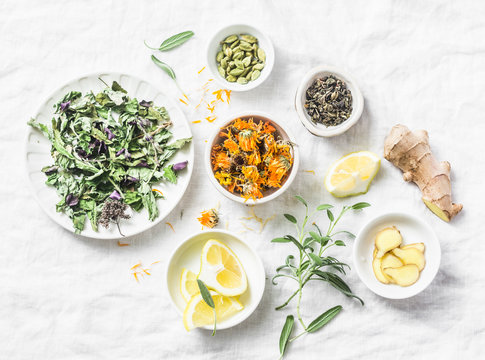 Ingredients for liver detox antioxidant tea on a light background, top view. Dry herbs, roots, flowers for homeopathy recipe for detox drink. Flat lay