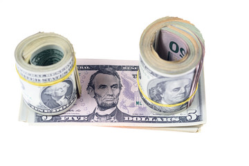 roll of banknotes of dollars and a stack of dollars isolated on white background
