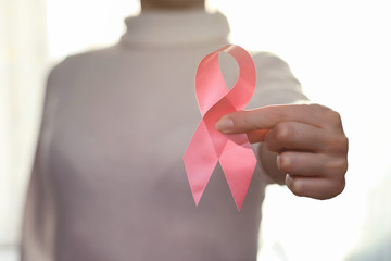 The red ribbon of the girl. The girl is holding a red ribbon. He