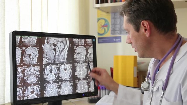 Doctor at the Monitor Describes CT Scan