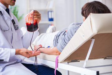 Patient getting blood transfusion in hospital clinic - obrazy, fototapety, plakaty