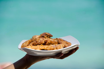 Fried banana in plate with woman hand ,seaside