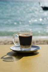 Close up Coffee cup on table and view of tropical beach.