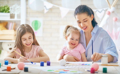 Fototapeta premium Mother and daughters painting together