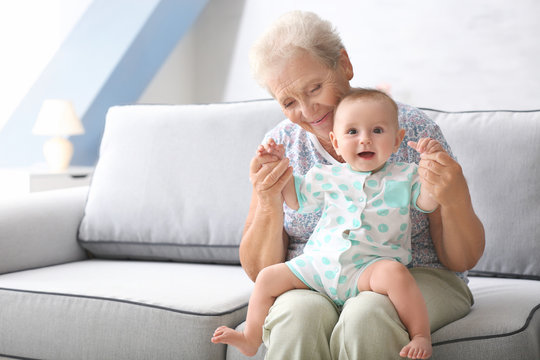 Senior woman playing with her little grandchild at home