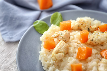 Plate with delicious pumpkin risotto on table