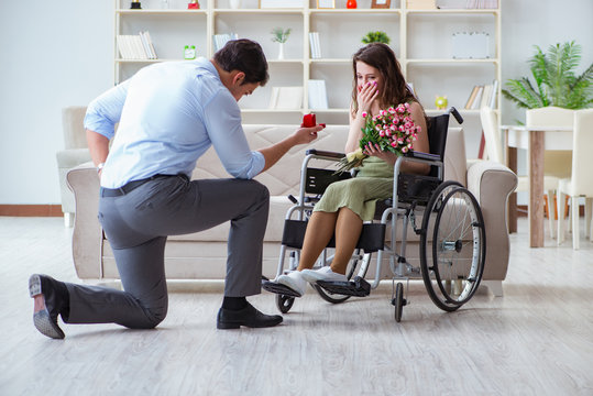 Man making marriage proposal to disabled woman on wheelchair