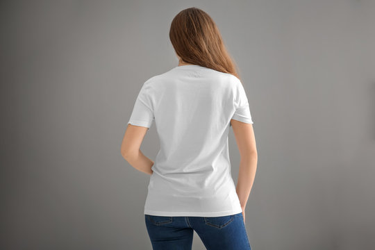 Young woman in stylish t-shirt on light background. Mockup for design