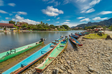 Fototapeta na wymiar Long exposure and long tail boats on naw song river in Vang vieng, Laos.