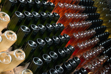 Sparkling wine bottles fermenting in winery