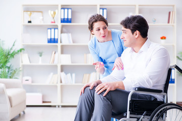 Disabled patient on wheelchair visiting doctor for regular check