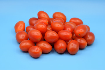 Little Red Grape Tomatoes on a Blue Background