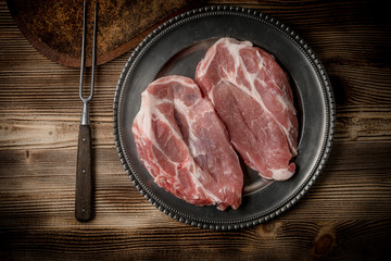 Slices of raw pork neck.